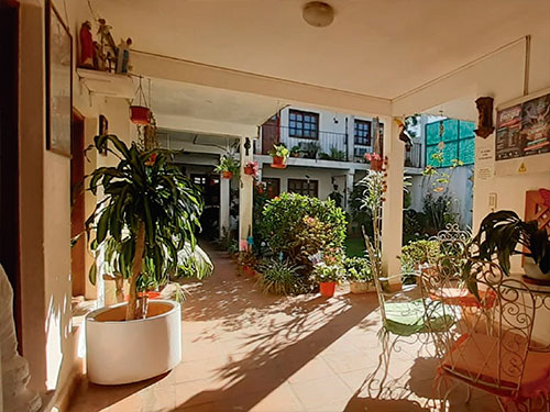 Galería con plantas junto al patio de la Hostería Champagne